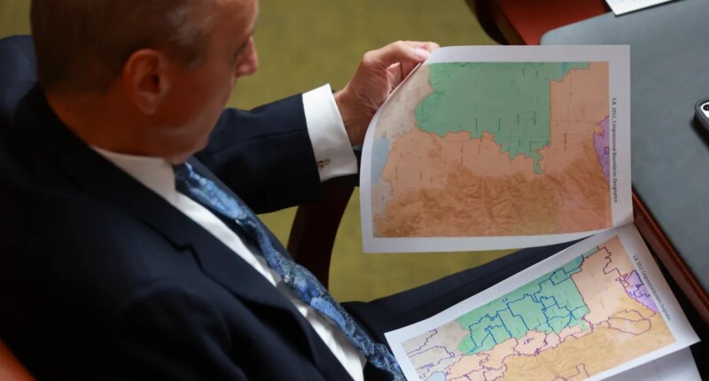 FILE -Rep. Cory Maloy, R-Lehi, holds a packet of potential redistricting maps as SB1012 Congressional Boundaries Designation is discussed in the House chamber during a special session at the Capitol on Monday, Oct. 6, 2025, in Salt Lake City. (Kristin Murphy/The Deseret News via AP, File)