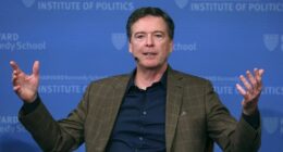 FILE - Former FBI director James Comey gestures while speaking at Harvard University's Institute of Politics' JFK Jr. Forum in Cambridge, Mass., Feb. 24, 2020. (AP Photo/Charles Krupa, File)