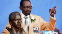 FILE - Former NFL player Kenny Easley poses with a bust of himself during an induction ceremony at the Pro Football Hall of Fame, Saturday, Aug. 5, 2017, in Canton, Ohio. (AP Photo/Ron Schwane, File)