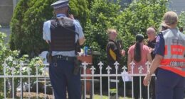 Police and animal control standing outside a home in Doonside after a dog attack that left a man seriously injured.