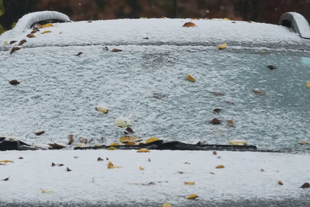 A car is covered with snow during a cold day in Evanston, Ill., Sunday, Nov. 9, 2025. (AP Photo/Nam Y. Huh)