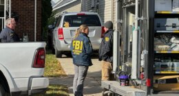 FBI agents gather outside a home in a Dearborn, Mich., neighborhood on Friday, Oct. 31, 2025. (AP Photo/Mike Householder)