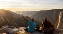 FILE - Visitors watch a sunset on rock ledge near Taft Point in Yosemite National Park, Calif., Oct. 30, 2025. (Stephen Lam/San Francisco Chronicle via AP, File)