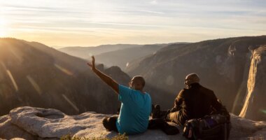 FILE - Visitors watch a sunset on rock ledge near Taft Point in Yosemite National Park, Calif., Oct. 30, 2025. (Stephen Lam/San Francisco Chronicle via AP, File)
