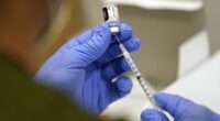 FILE - A healthcare worker fills a syringe with the Pfizer COVID-19 vaccine at Jackson Memorial Hospital on Oct. 5, 2021, in Miami. (AP Photo/Lynne Sladky, File)