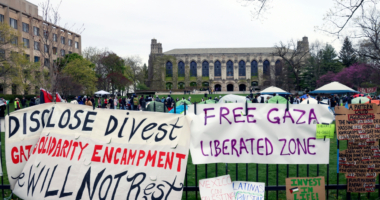 FILE - Signs are displayed outside a tent encampment at Northwestern University on April 26, 2024, in Evanston, Illinois. (AP Photo/Teresa Crawford, file)