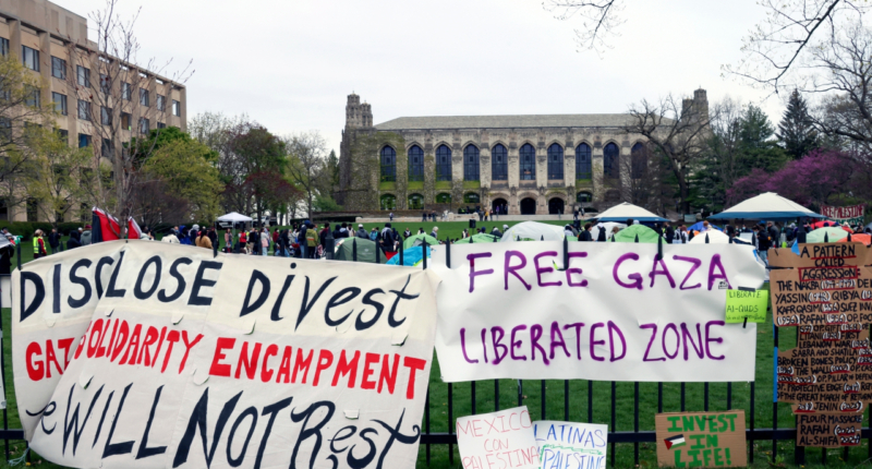 FILE - Signs are displayed outside a tent encampment at Northwestern University on April 26, 2024, in Evanston, Illinois. (AP Photo/Teresa Crawford, file)