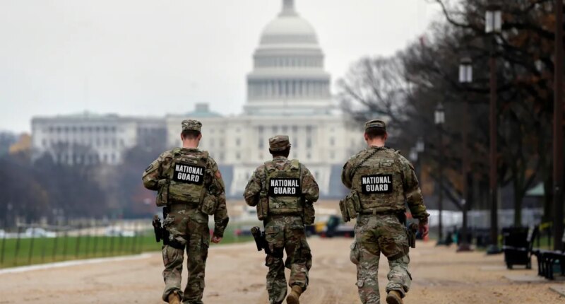 National Guard patrol along the National Mall in front of the Capitol, Wednesday, Nov. 26, 2025, in Washington. (AP Photo/Rahmat Gul)