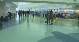 'See him in 3D today': Travelers embrace loved ones at airport gate during busiest day of travel