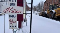A snowplow operates outside a church in Lowville, N.Y., on Friday, Nov. 28, 2025. (AP Photo/Cara Anna)