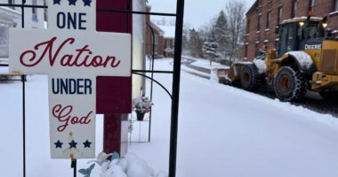 A snowplow operates outside a church in Lowville, N.Y., on Friday, Nov. 28, 2025. (AP Photo/Cara Anna)