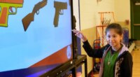 Jailyn Martinez points to a real firearm during a gun safety lesson at Berclair Elementary School, Monday, Oct. 27, 2025, in Memphis, Tenn. (AP Photo/George Walker IV)