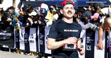 Lukas Schindler from Switzerland crossing the finish line at the Sydney marathon.