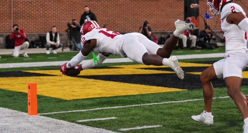 Indiana defensive back Devan Boykin (12) dives over the goal line as he returns a fumble for a touchdown during the second half of an NCAA college football game against Maryland, Saturday, Nov. 1, 2025, in College Park, Md. (AP Photo/Stephanie Scarbrough)