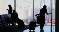Travelers wait at a gate for their departing flight at the Dallas Fort Worth International Airport, at DFW Airport, Texas, Friday, Nov. 21, 2025. (AP Photo/Tony Gutierrez)