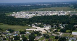 FILE - The Fifth Ward Elementary School and residential neighborhoods sit near the Denka Performance Elastomer Plant, back, in Reserve, La., Sept. 23, 2022. (AP Photo/Gerald Herbert, File)