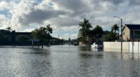 A local pond overflows into a residential neighborhood in Huntington Beach, Calif. following a storm on Friday, Nov. 21, 2025. (AP Photo/Amy Taxin)