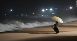 People watch rough waves caused by Typhoon Kalmaegi in Khanh Hoa, Vietnam on Thursday, November 6.