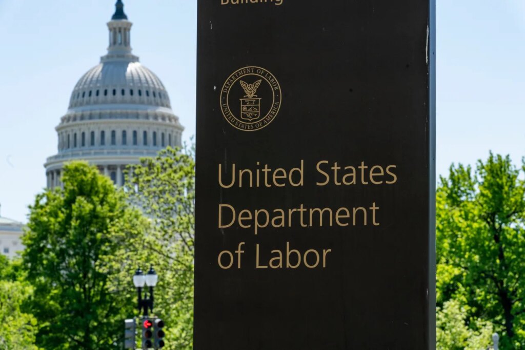 FILE - In this May 7, 2020, file photo, the entrance to the Labor Department is seen near the Capitol in Washington. (AP Photo/J. Scott Applewhite, File)