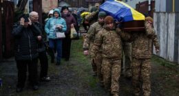 An honor guard carries the coffin of Ruslan Zhygunov, a Ukrainian serviceman, who was killed at the frontline near Rusyn Yar village, during his funeral ceremony in Hostomel, Ukraine. Ukraine's allies pushed back against Donald Trump's proposed peace plan, saying it favoured Russia.