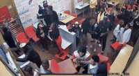gif of rowdy crowd causing a fight inside a domino