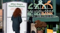 A person walks toward the entrance of the Capital Area Food Bank, Thursday, Nov. 6, 2025, in Washington. (AP Photo/Mark Schiefelbein)