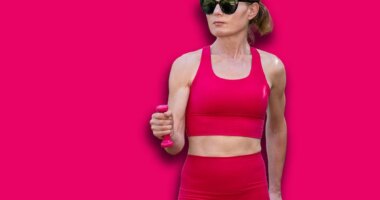 fit sporty woman exercising outdoors with hand weights, power walking