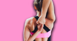 Beautiful young woman practices yoga asana Gomukhasana - Cow face pose at the yoga studio.