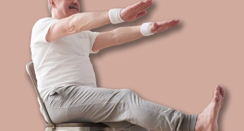Elderly man practicing yoga asana or sport exercise for legs and hands on chair