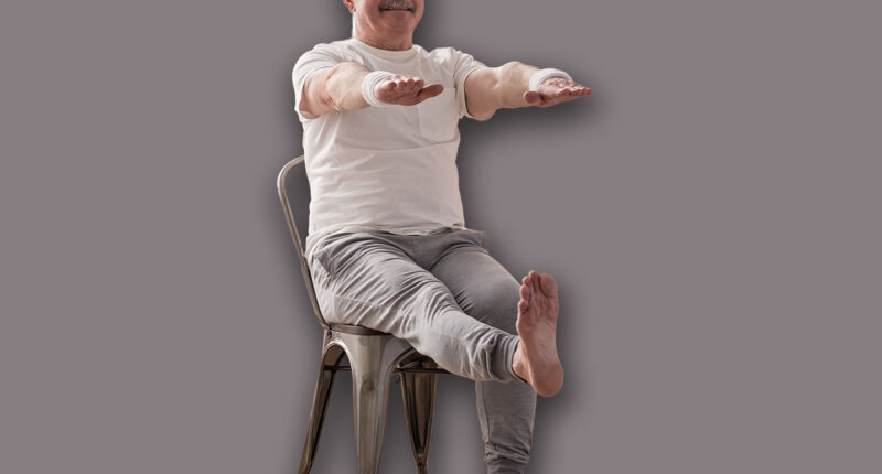 Elderly man practicing yoga asana or sport exercise for legs and hands on chair