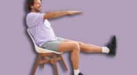 Middle age man smiling confident sitting on chair stretching at sport center
