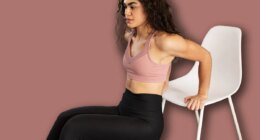 Athletic latin woman in her 20s working out her arms with tricep dips exercises. Good-looking woman using a chair for her home workout