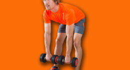 dumbbell deadlift blond man at gym weightlifting with swiss ball background