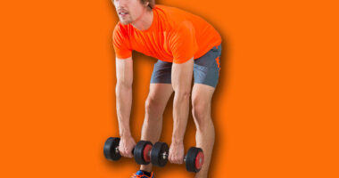 dumbbell deadlift blond man at gym weightlifting with swiss ball background