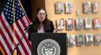 FILE - Survivor of gun violence Mia Tretta speaks while standing next to a wall with photographs of victims of gun violence during the Inaugural Gun Violence Survivors