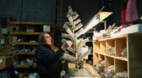 Melissa Webb assembles an artificial Christmas tree at Lee Display
