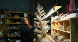 Melissa Webb assembles an artificial Christmas tree at Lee Display
