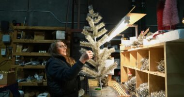 Melissa Webb assembles an artificial Christmas tree at Lee Display