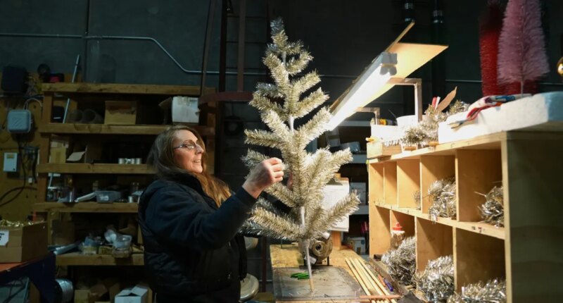Melissa Webb assembles an artificial Christmas tree at Lee Display