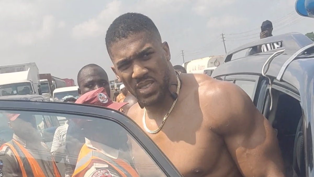 Anthony Joshua will spend New Year's Eve in luxury Nigerian hospital recovering from crash that killed his two friends - as police say tyre blowout caused high-speed wreck