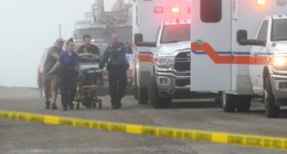 Emergency personnel rush a victim of a small plane crash to an awaiting ambulance, Monday, Dec. 22, 2025, near the causeway, in Galveston, Texas. (Jennifer Reynolds/The Galveston County Daily News via AP)