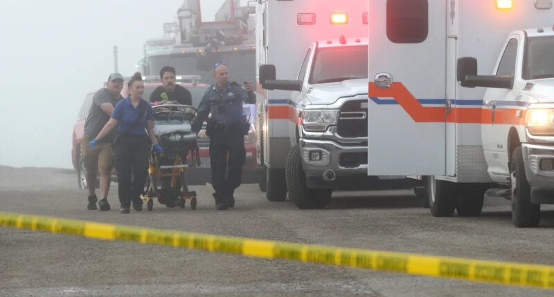 Emergency personnel rush a victim of a small plane crash to an awaiting ambulance, Monday, Dec. 22, 2025, near the causeway, in Galveston, Texas. (Jennifer Reynolds/The Galveston County Daily News via AP)
