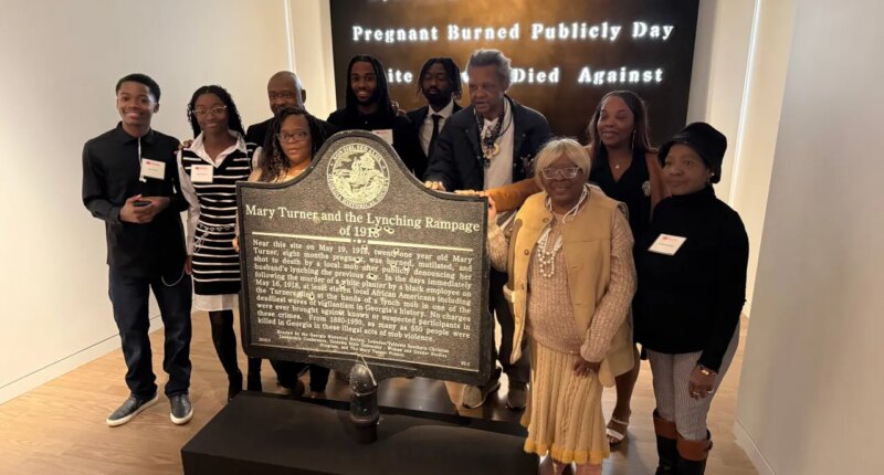 Descendants of Mary Turner, who was lynched in 1918, pose with her historic marker and artist Lonnie Holley, fourth from left, at the National Center for Civil and Human Rights, on Dec. 6, 2025 in Atlanta. (AP Photo/Michael Warren)