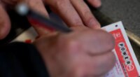 A person fills out a Powerball lottery ticket on Monday, Dec. 22, 2025, in Portland, Ore. (AP Photo/Jenny Kane)