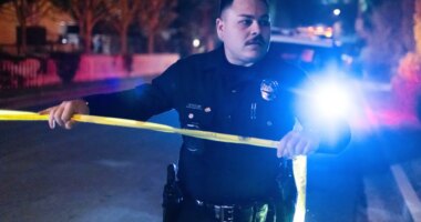 A police officer blocks off a street near Rob Reiner