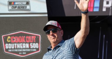 FILE - Former driver Greg Biffle waves to fans prior to a NASCAR Cup Series auto race at Darlington Raceway, Aug. 31, 2025, in Darlington, S.C. (AP Photo/Matt Kelley, File)
