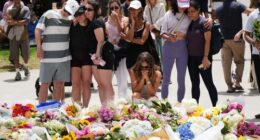 Emotions are high as locals continue to flock to Bondi Beach to lay flowers.