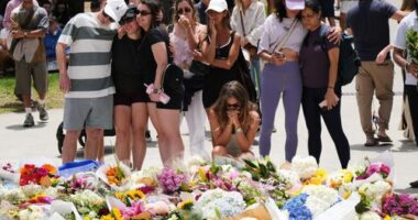 Emotions are high as locals continue to flock to Bondi Beach to lay flowers.