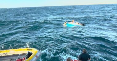 Heavy swell threw the four men out of their 5.7 aluminium cruiser into the ocean.