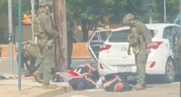 Multiple men were seen in handcuffs.